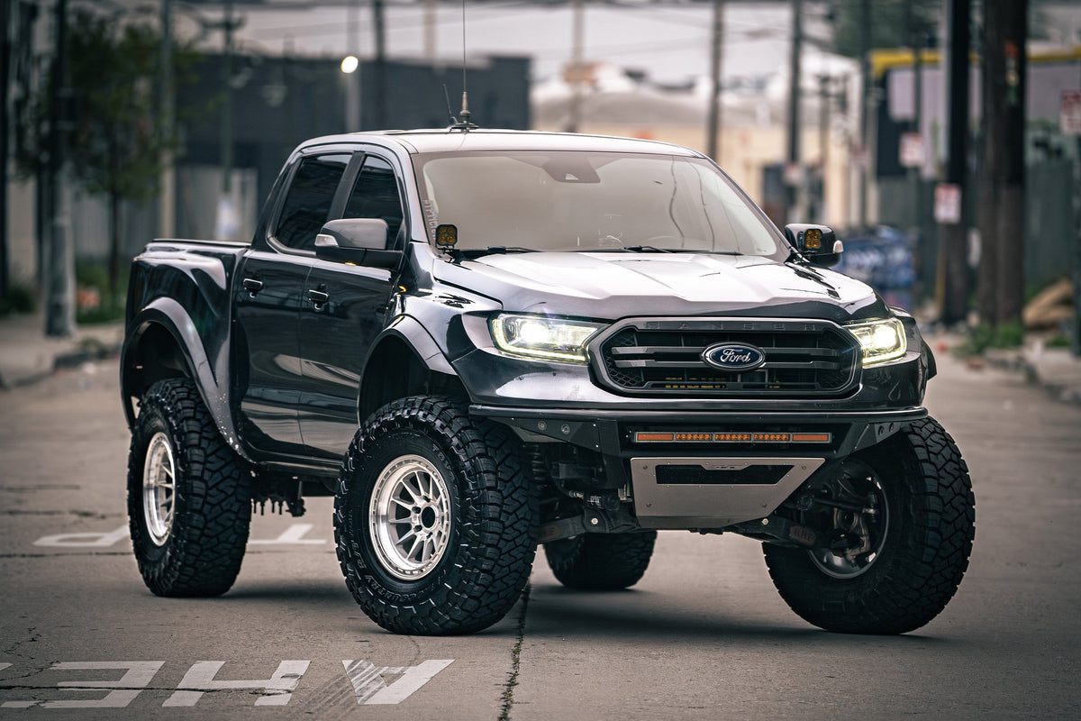 Black Ford Ranger on Lock Off-Road Baja wheels in Machine Face, front three-quarter view