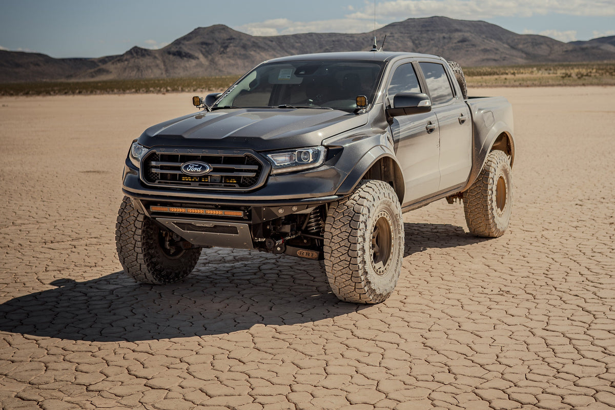 Ford Ranger on Lock Off-Road Olympus wheels on a dry lake bed, front three-quarter view
