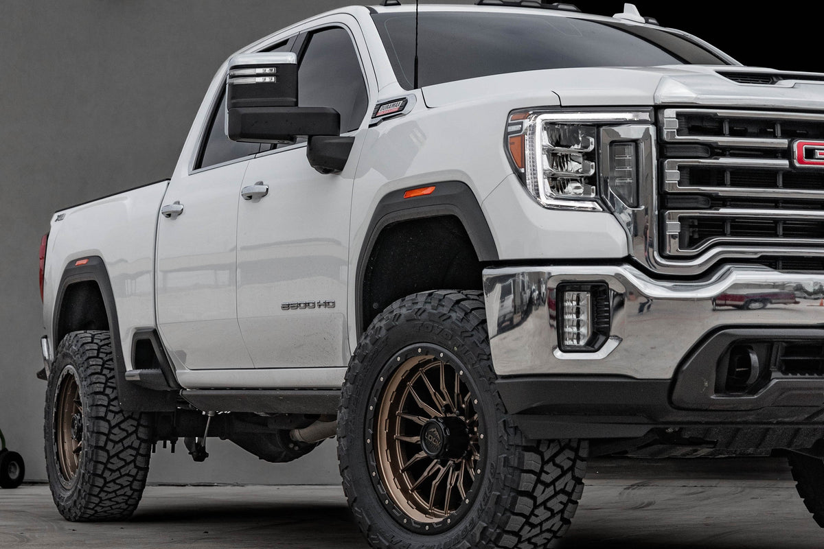 White GMC Sierra 2500 on Lock Off-Road Krawler 22x10 wheels, front three-quarter view