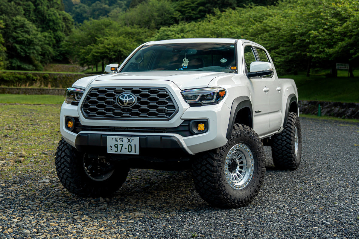 White 3rd Gen Toyota Tacoma on Lock Off-Road Mojave wheels, front three-quarter view