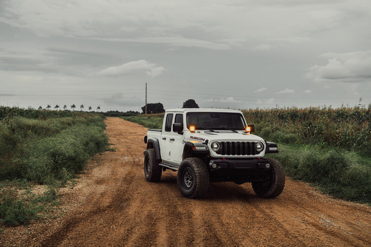 White Jeep Gladiator Rubicon on Lock Off-Road Commando wheels on a dirt road