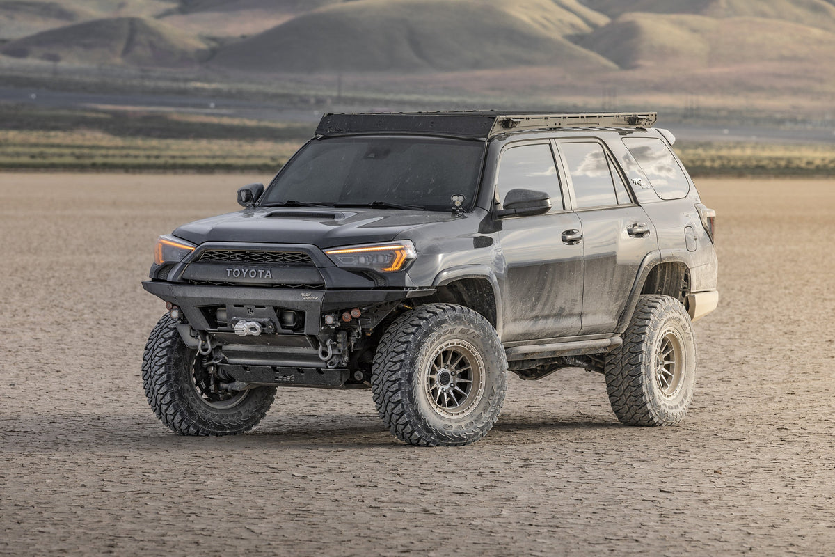 Toyota 4Runner on Lock Off-Road Baja wheels, front three-quarter view on a dry lake bed